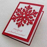 Jõulukaart suure punase lumehelbemotiiviga